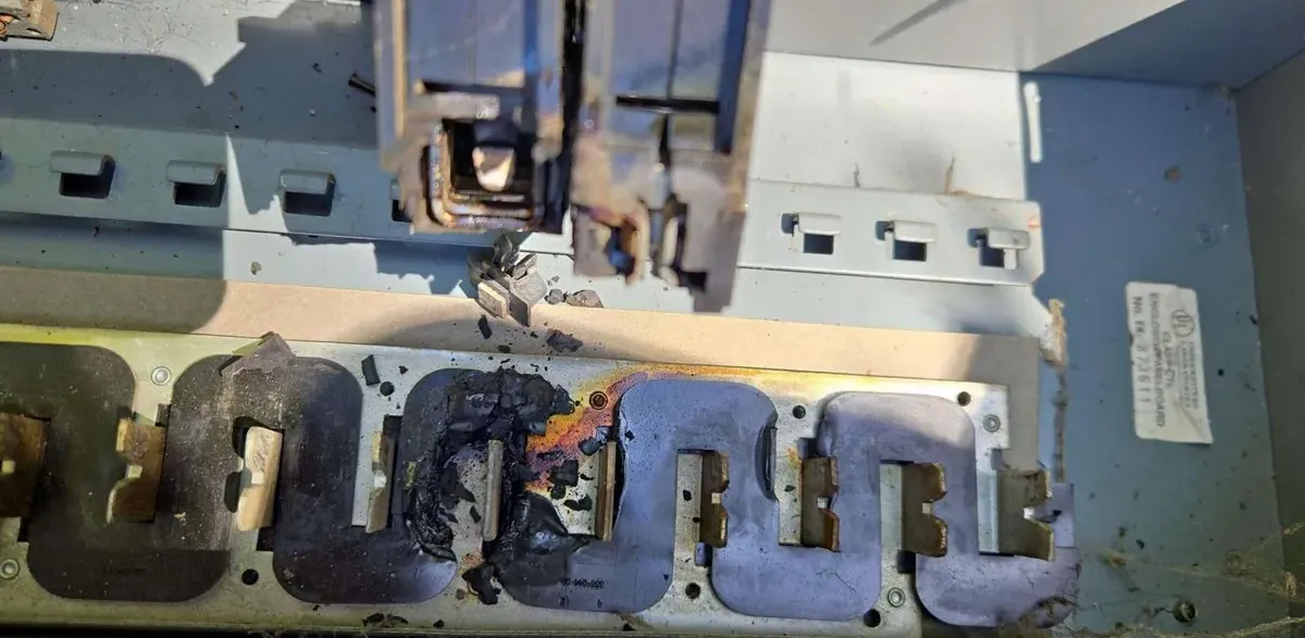 Heat-damaged electrical panel bus bar, a clear sign a panel upgrade is needed