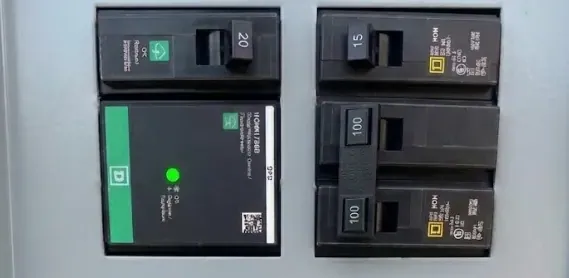 Whole-house surge protector with a green status light installed in a Square D panel