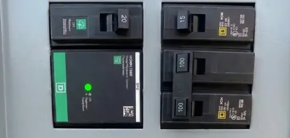 Whole-house surge protector with a green status light installed in a Square D panel