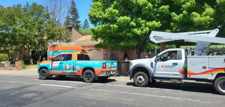 Peach Electric trucks on site with a SMUD utility crew during a panel upgrade in Sacramento