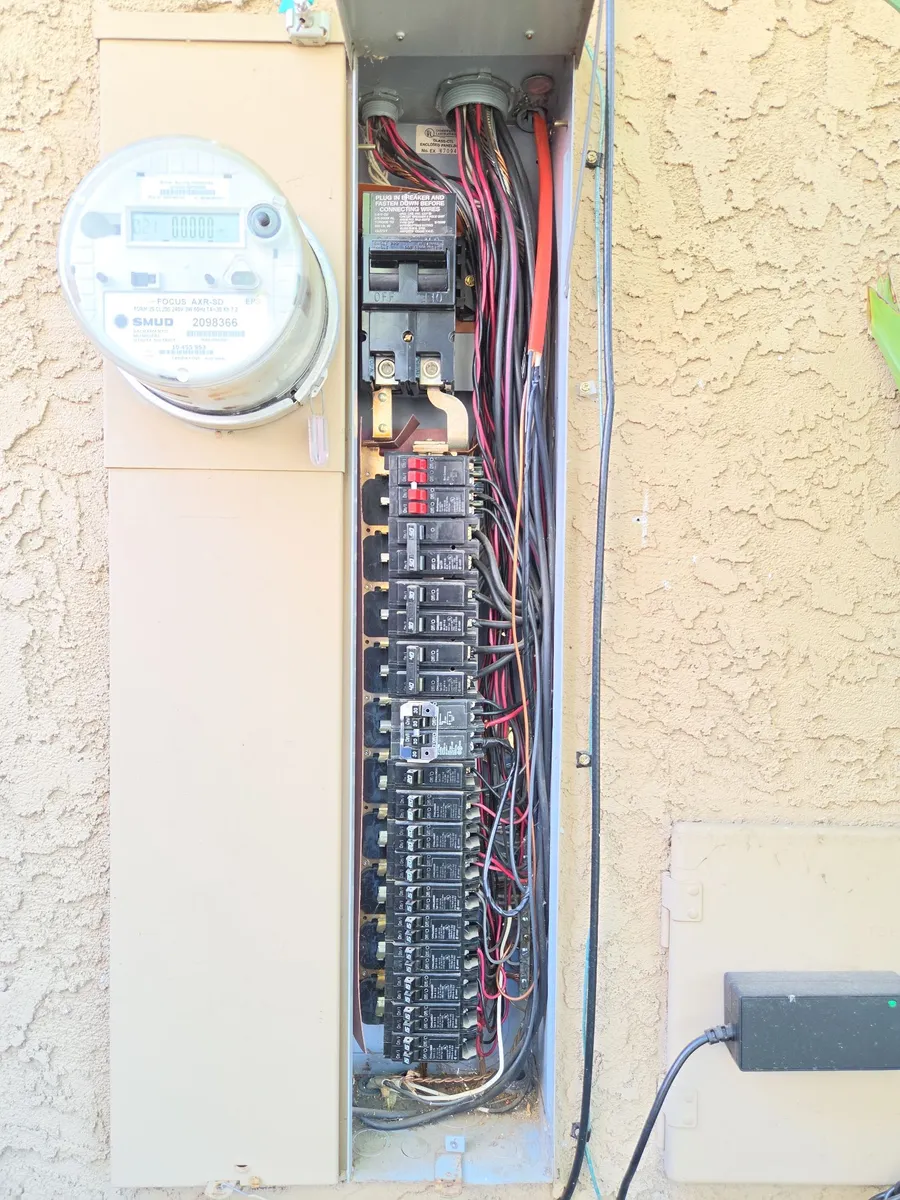 Challenger meter main on a Fair Oaks home: SMUD meter on the left, main breaker and a full column of branch breakers on the right