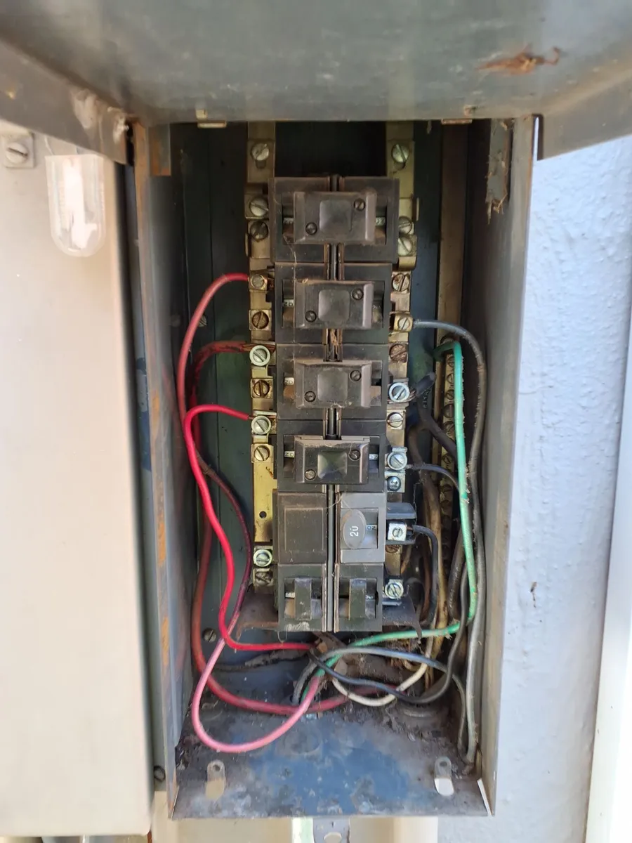 Pushmatic panel in a Sacramento home with its push-button breakers, no main breaker, and decades of dust inside the cabinet